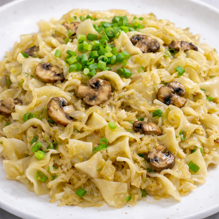 Traditional cabbage noodles with sauerkraut and sautéed mushrooms. A simple Central European recipe full of flavor, balancing acidity, umami, and comfort.