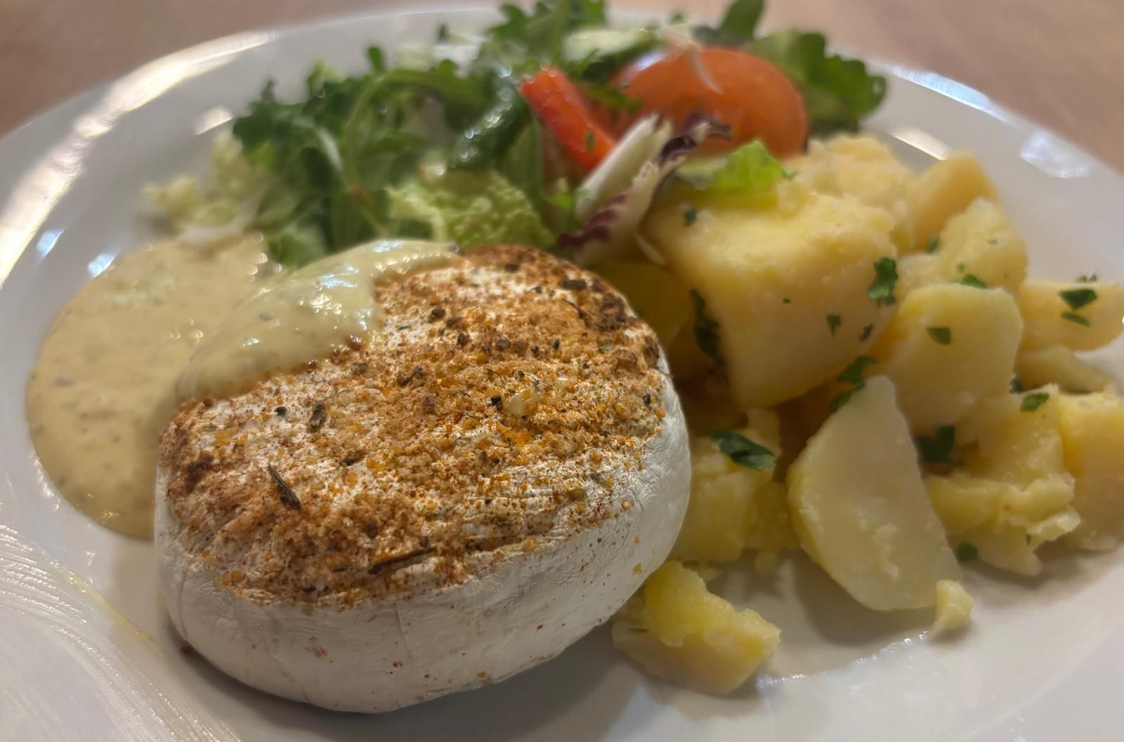 Grilled Camembert with roasted garlic and caper mayo, buttered potatoes and fresh salad