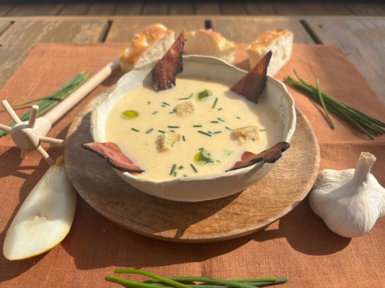 Slovak Demikát bryndza soup with crispy bacon and chive oil