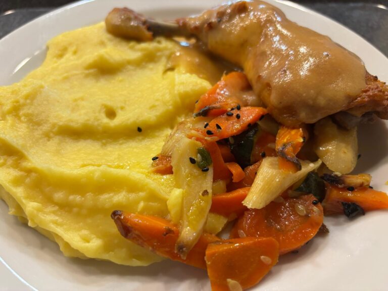 Baked chicken thigh with cheddar mashed potatoes and roasted vegetables