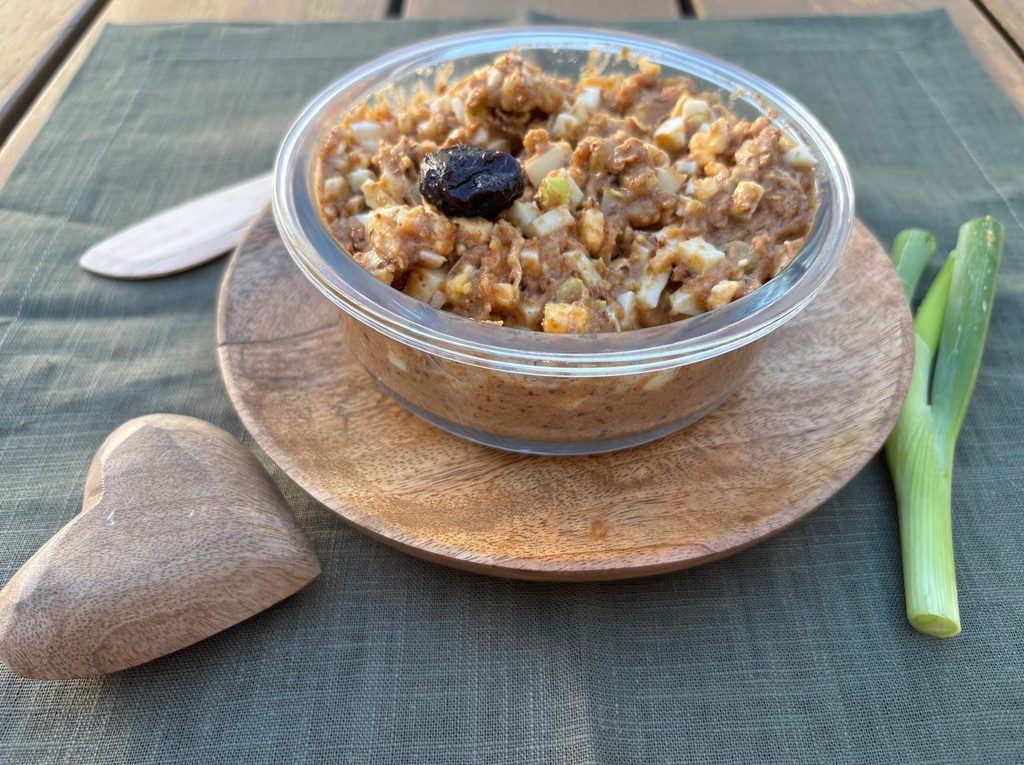 Homemade pork crackling spread with prunes and hard-boiled egg